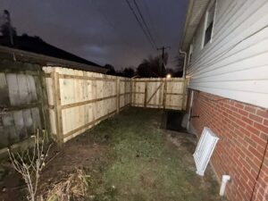 A newly installed wood privacy fence in a residential backyard by Raatz Fence Company in Louisville, KY.