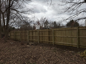A newly installed wood privacy fence providing security and aesthetic appeal by Red Lake Fencing & Construction in Springfield, MA.