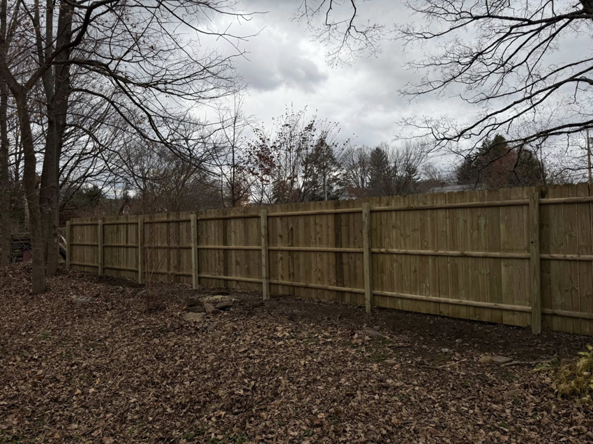 A newly installed wood privacy fence providing security and aesthetic appeal by Red Lake Fencing & Construction in Springfield, MA.