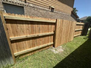 A newly installed wood privacy fence providing privacy for a residential property by Stand Strong Fencing of East Austin, TX.