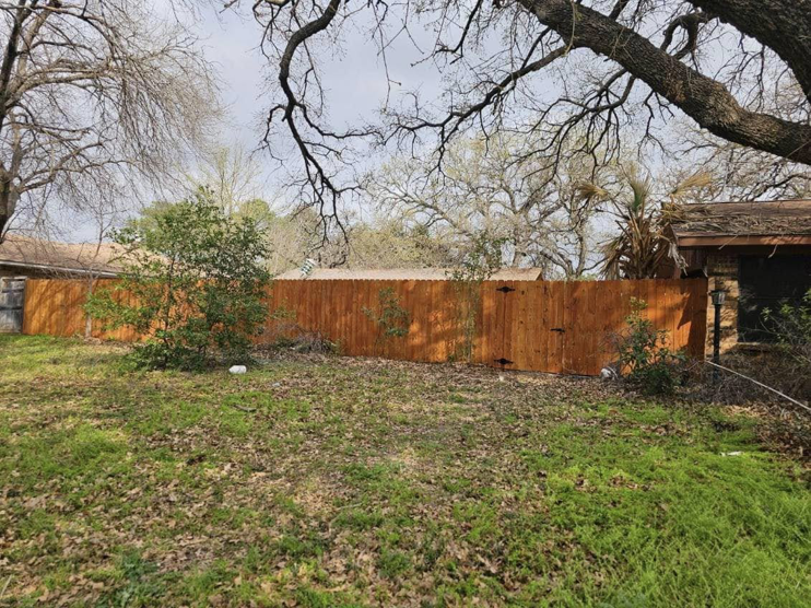 A newly installed wood privacy fence completed by Straight Shot Solutions, LLC in Fort Worth, TX.