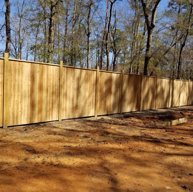 A newly installed wood privacy fence by Weber Fence LLC in a residential area of Baton Rouge, LA.