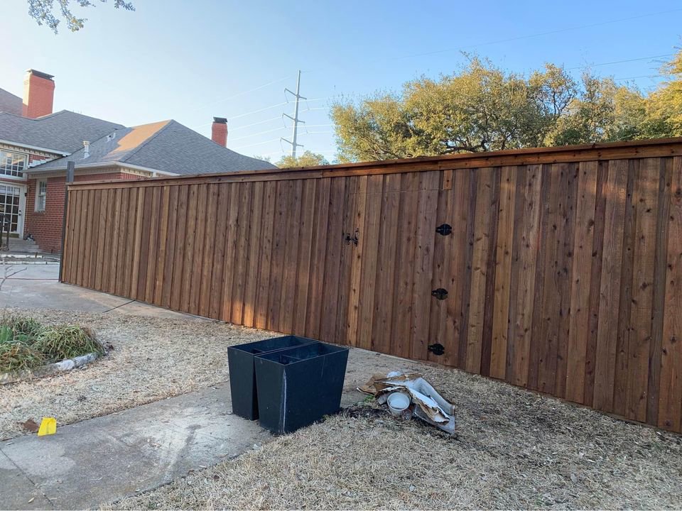A newly installed wooden privacy fence featuring a functional gate, expertly built by Reliable Texas Fencing in Fort Worth, TX.