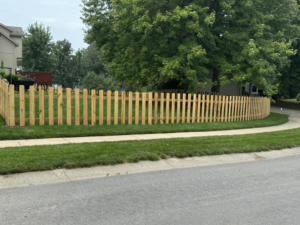 A newly installed wooden picket fence by Decked Out Fencing in Kansas City, MO