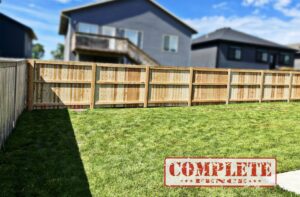 A newly installed wooden privacy fence enclosing a backyard by Complete Fence, LLC in West Chicago, IL