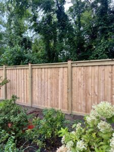 A newly installed wooden privacy fence in a backyard by Creative Fence Designs in Columbus, GA.