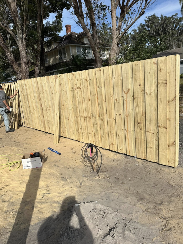 A newly installed wooden privacy fence by North East Fence and Forestry, showing quality craftsmanship in North Bay, ON.