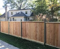 A long section of a newly installed wooden privacy fence by Pokey Fencing & Masonry, providing security in Stillwater, OK.