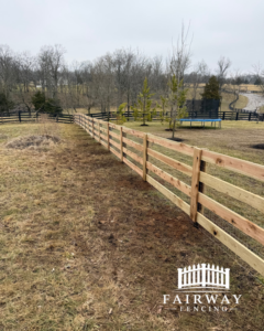 A newly installed wooden split-rail style fence stretching across a grassy field by Fairway Fencing in Lexington, KY.