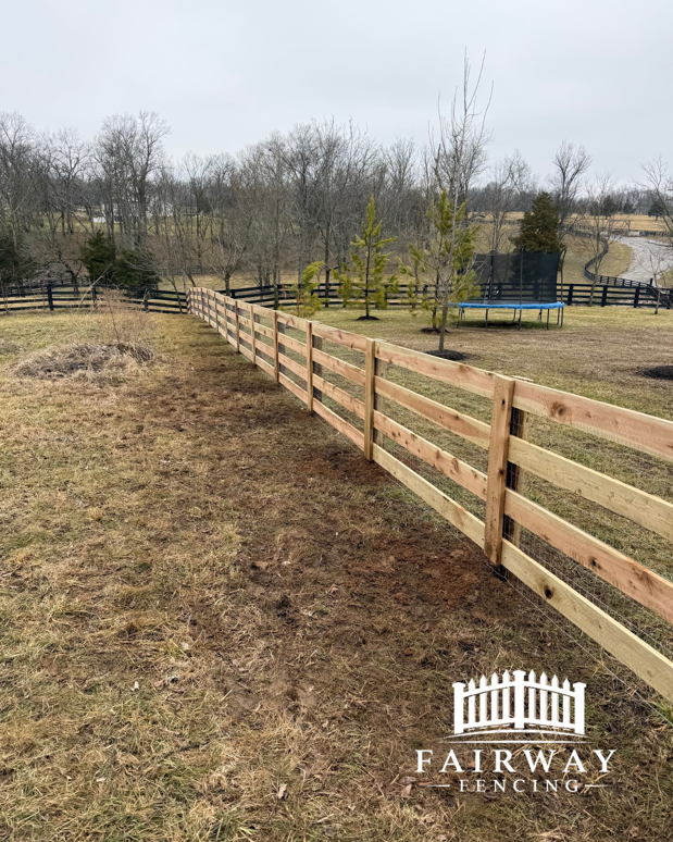 A newly installed wooden split-rail style fence stretching across a grassy field by Fairway Fencing in Lexington, KY.