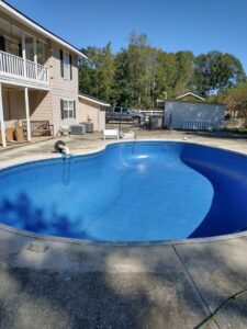 A newly lined pool being filled with water from a hose, a service provided by Brian's Pool Service in Baton Rouge, LA.