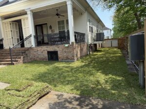 A freshly installed sod lawn next to a residential house, showcasing lawn care services by God's Sight Lawn & Gardens LLC in New Orleans, LA