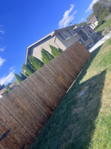 A newly stained or cleaned wooden privacy fence installed by 4Seasons Pools & Pressure Washing in Omaha, NE.