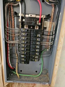 A newly installed and neatly wired electrical panel with circuit breakers, completed by Titus & Son's Electric in Bluffton, IN.