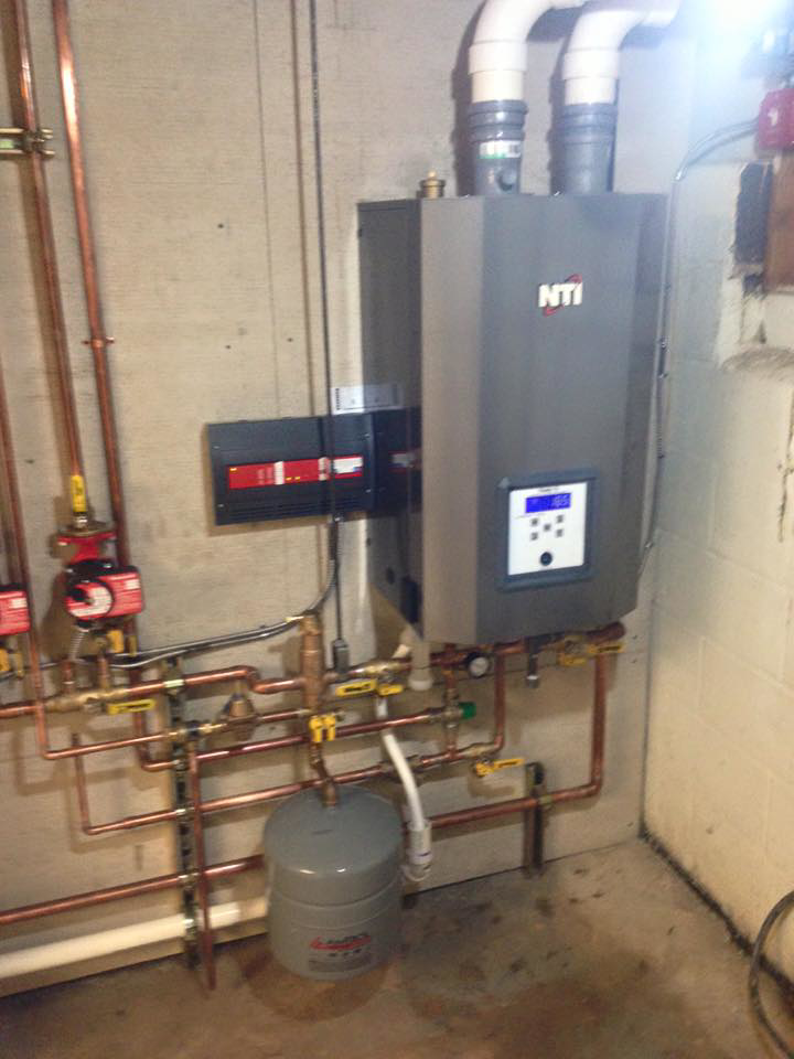A newly installed NTI boiler and water heating system with copper piping by Green Planet Solutions Corporation in Moscow, PA.