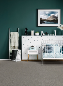 A stylish nursery room with a new gray carpet installation by Wilkins Floorcovering in Livonia, MI
