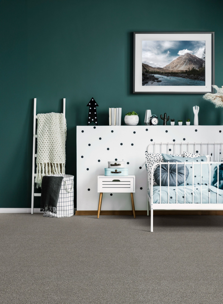 A stylish nursery room with a new gray carpet installation by Wilkins Floorcovering in Livonia, MI
