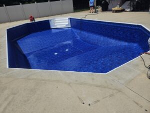 A newly installed octagonal pool liner being filled with water, demonstrating pool liner services by Westside Pools in Owensboro, KY.