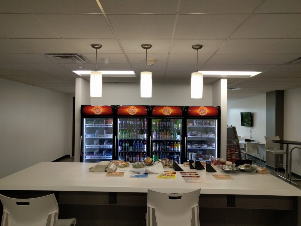 Office breakroom featuring modern pendant and recessed lighting installed by VIP Electrical Services in Naperville, IL.
