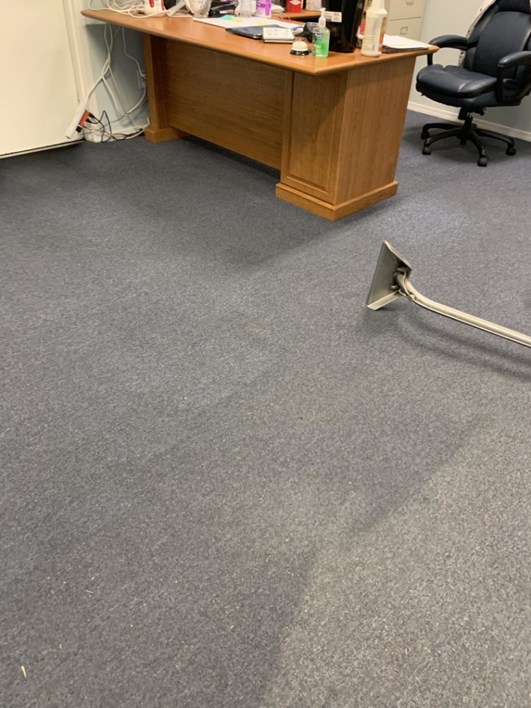 Professional office carpet cleaning in progress by Eagle 1 Carpet Cleaning in Reno, NV, showing a clean path.