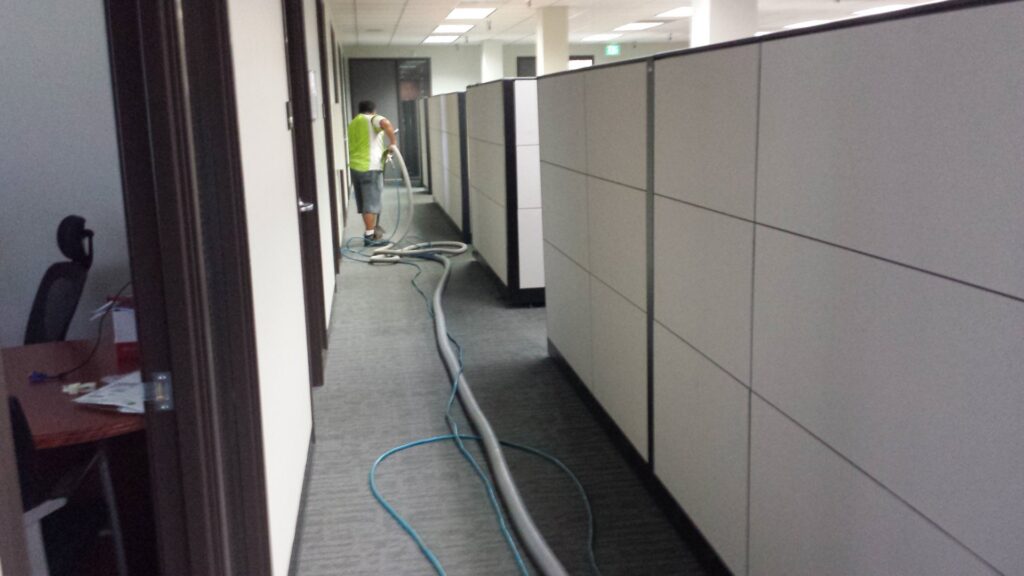 An employee of Harper's Cleaning Services cleaning office carpets in a commercial building in Anaheim, CA.