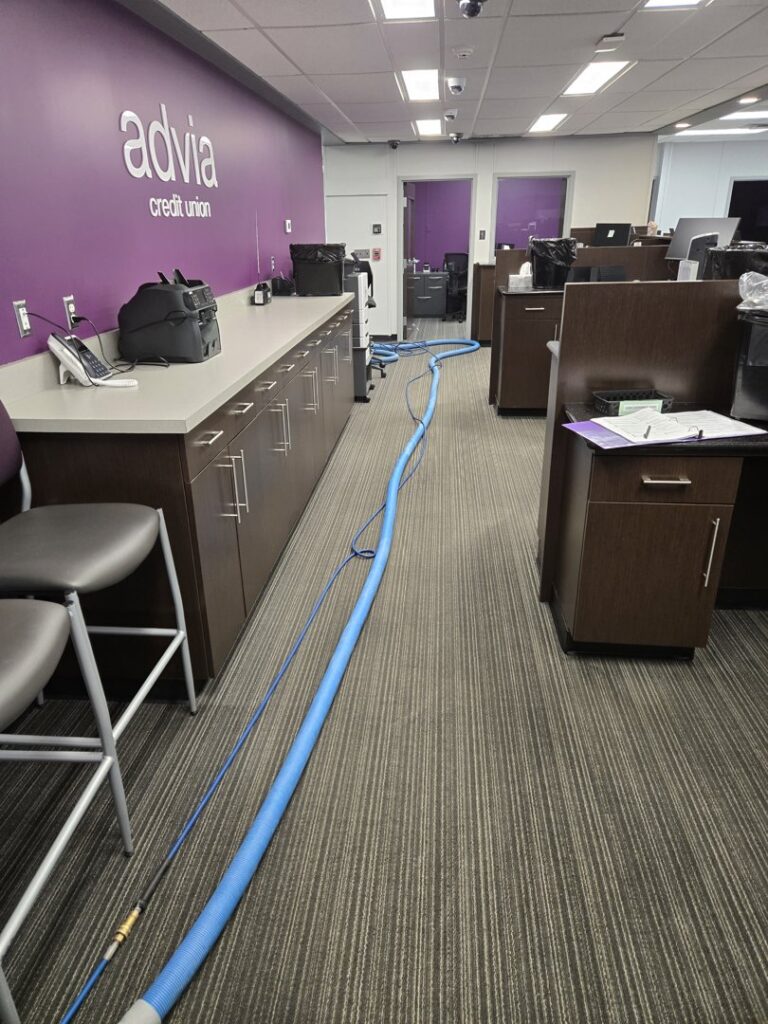 Office carpet cleaning setup with hoses laid out on striped commercial carpet by On The Spot Carpet and Upholstery Cleaning in Warren, MI.