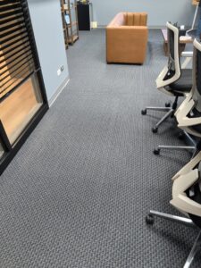 A wider view of new carpet installed in a modern office space by AguirreFloorz in Colorado Springs, CO.