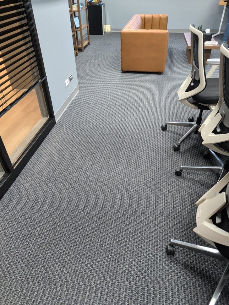 A wider view of new carpet installed in a modern office space by AguirreFloorz in Colorado Springs, CO.
