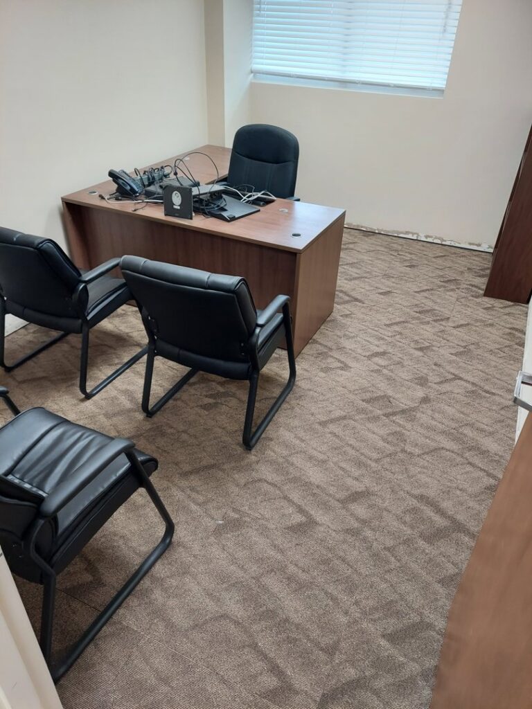 Brown patterned carpet tiles installed in an office room by Palmetto Carpet Company in Miami, FL.