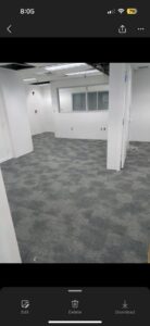 Newly installed grey patterned carpet tiles in an office space by Reserved Installations LLC in Orlando, FL