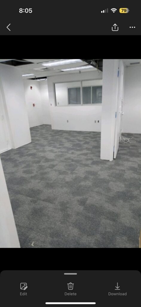 Newly installed grey patterned carpet tiles in an office space by Reserved Installations LLC in Orlando, FL