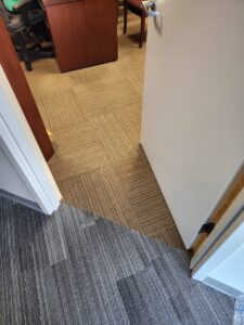 Carpet tile installation showing a transition between two patterns in an office by Carpet Center in Wilmington, NC.