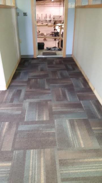A newly installed carpet tile floor in an office corridor, completed by Flooring Authority, Inc. in Amsterdam, NY.