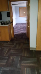 An office hallway featuring a professional carpet tile installation by Flooring Authority, Inc. in Amsterdam, NY.