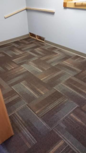 An office room featuring a professional carpet tile flooring installation by Flooring Authority, Inc. in Amsterdam, NY.
