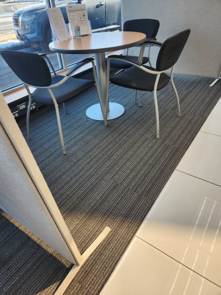 Striped carpet tile installation in a modern office seating area by Carpet Center in Wilmington, NC.