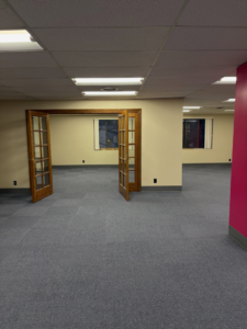An office space featuring new blue carpet tile flooring installed by Basics Flooring in Natick, MA.