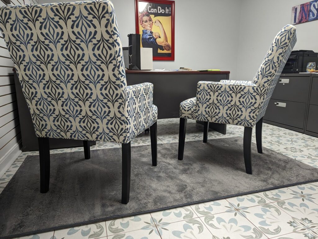 An office space featuring a gray area rug over decorative tile flooring, showcasing options from Petersen's Carpet & Flooring in Frederick, MD
