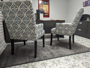 An office space featuring a gray area rug over decorative tile flooring, showcasing options from Petersen's Carpet & Flooring in Frederick, MD