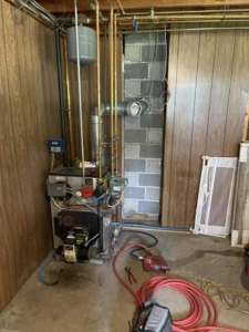 An oil boiler heating system with tools, indicating maintenance by Aaron Hamilton Heating in Brunswick, ME.