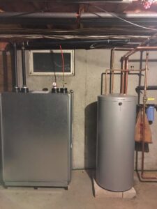 An oil burner furnace and a water heater tank installed by Nate's Oil Burner Service in New Bedford, MA