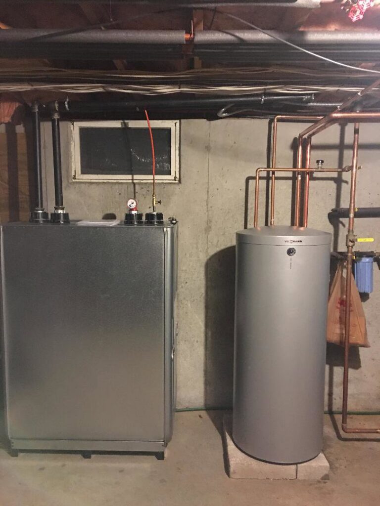 An oil burner furnace and a water heater tank installed by Nate's Oil Burner Service in New Bedford, MA