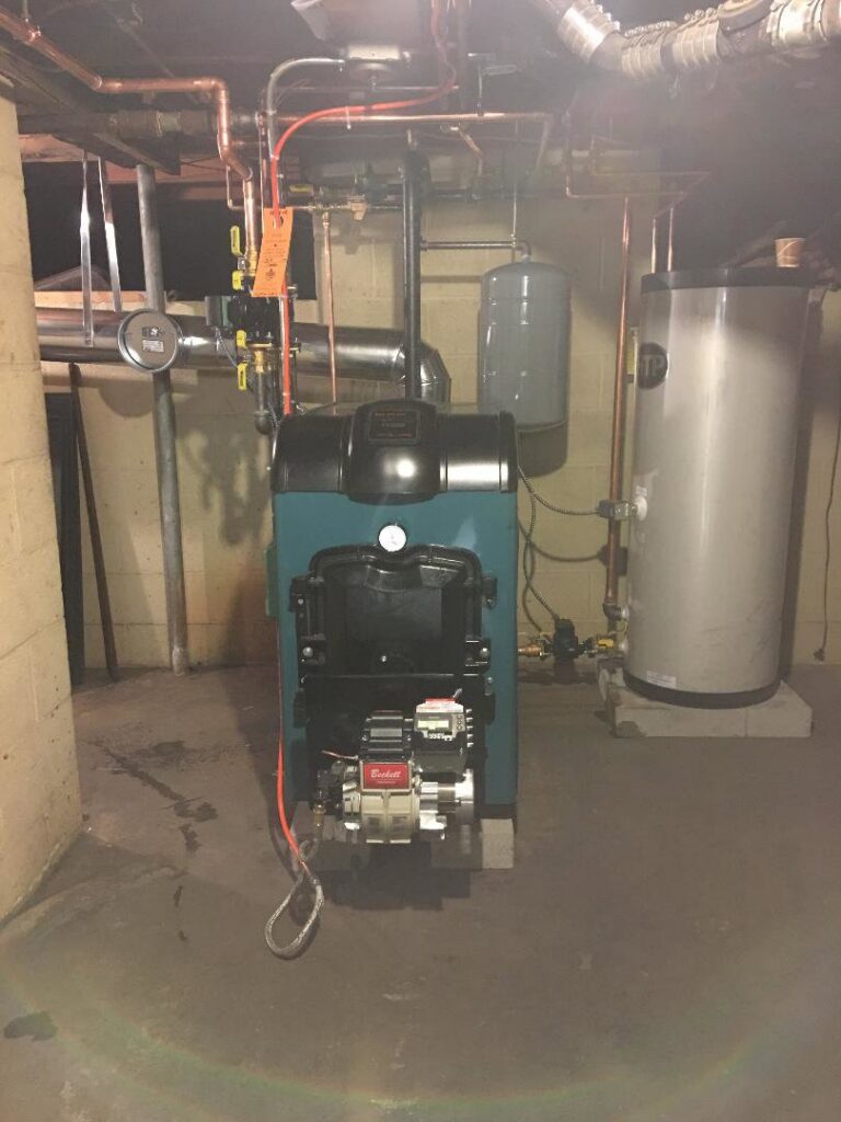 An older model oil burner furnace and water heater system serviced by Nate's Oil Burner Service in New Bedford, MA
