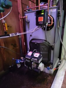 A new oil burner furnace installation with a Beckett burner in a utility room by L&SON Heat AC Tech in Yonkers, NY.