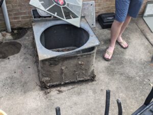 An old, dirty outdoor AC unit being replaced by Honesty Services in Rock Hill, SC.