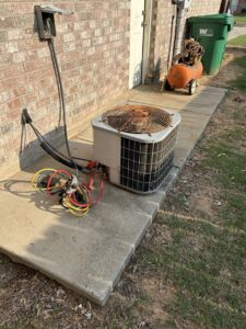 An old, rusty outdoor AC unit being serviced or prepared for replacement by Oklahoma Climate Solutions in Oklahoma City, OK.