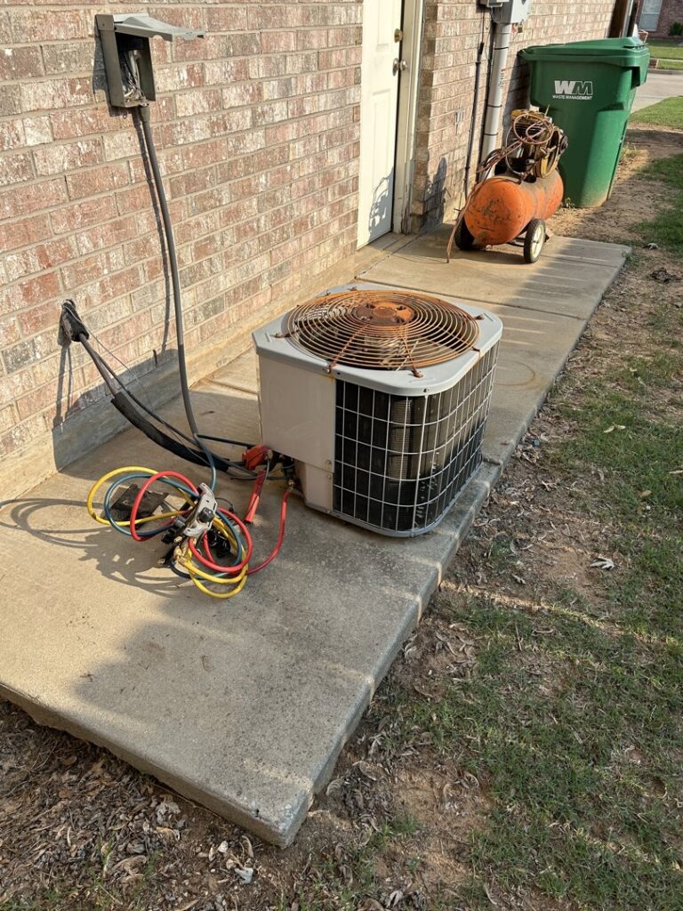 An old, rusty outdoor AC unit being serviced or prepared for replacement by Oklahoma Climate Solutions in Oklahoma City, OK.