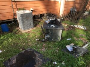 An old, damaged outdoor AC unit next to a newer one, indicating HVAC replacement work by The A/C Guy in Shreveport, LA.