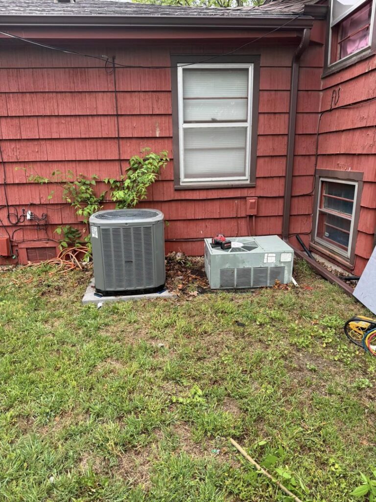 An old AC unit next to a new one, indicating a replacement job by G.M. AIR Conditioning & Heating in Wichita, KS.