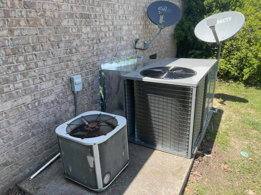 An old outdoor HVAC unit next to a newly installed larger unit with new ductwork by Wright Air Care in Murfreesboro, TN.
